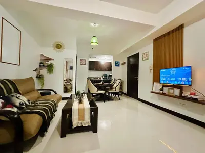 a living room with a couch and a television at Staycation in Manhattan by House of Mereu in Manila