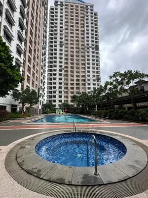 a large swimming pool in front of a tall building at Staycation in Manhattan by House of Mereu in Manila