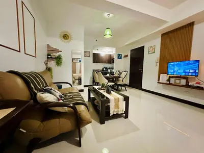 a living room with a couch and a tv at Staycation in Manhattan by House of Mereu in Manila