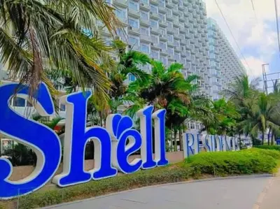 a large hotel sign in front of a building at Pasay Moa Stay at Shell Residences in Manila