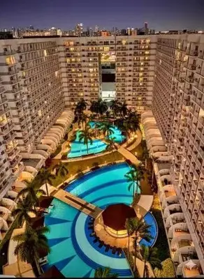an overhead view of a large building with a swimming pool at Pasay Moa Stay at Shell Residences in Manila