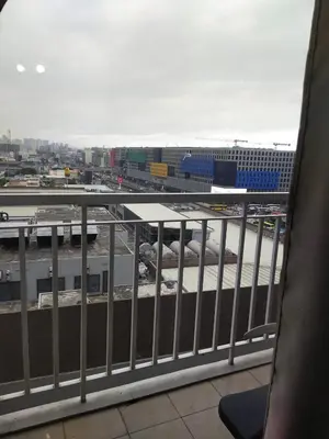 a view of a stadium from a balcony at Pasay Moa Stay at Shell Residences in Manila