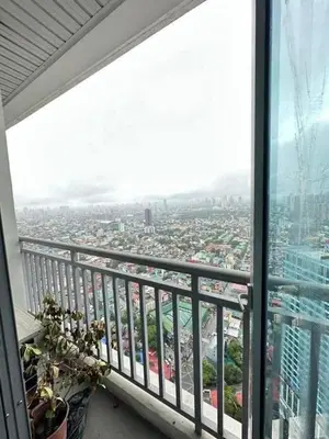 a balcony with a view of a city at Vacation in Tribecca Towers in Manila