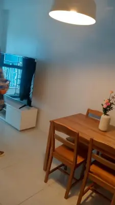a dining room with a table and a tv at Charmimg 1 BR with Natural Light in Manila