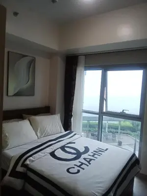 a bedroom with a bed with a sign on it at Cozy Retreat 3 BR unit The Bayshore in Manila