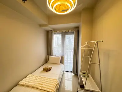a small room with a bed and a ladder at S Residences Family Room 512 by Prime Stay MOA in Manila