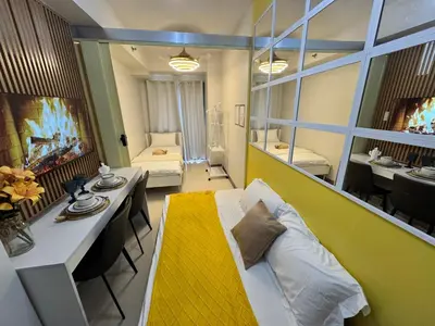 a living room with a couch and a dining room at S Residences Family Room 512 by Prime Stay MOA in Manila