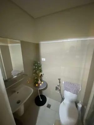 a bathroom with a toilet and a sink at H&M staycation Shore 2 tower 2 in Manila