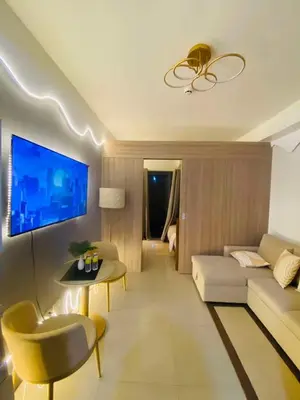 a living room with a couch and a tv at H&M staycation Shore 2 tower 2 in Manila