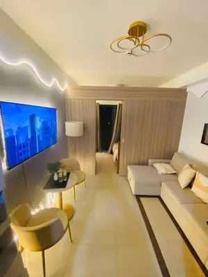 a living room with a couch and a table at H&M staycation Shore 2 tower 2 in Manila