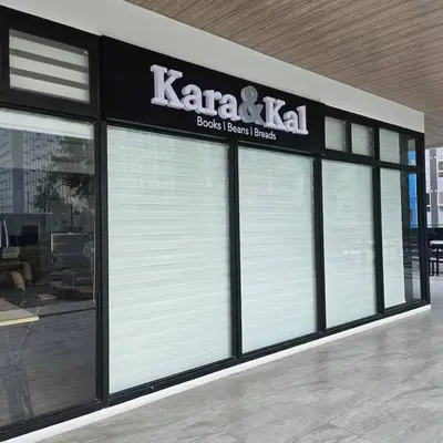 a store with white garage doors in a building at Coco Home in Manila