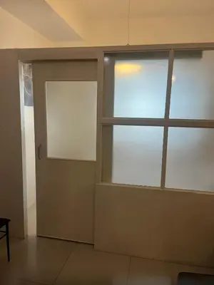 an empty room with a door and a window at Hotel Essence Service Road in Manila