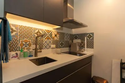 a kitchen with a sink and a microwave at Century Spire Condominium, Makati City in Manila