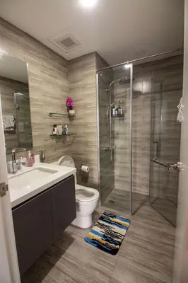a bathroom with a shower and a toilet and a sink at Century Spire Condominium, Makati City in Manila