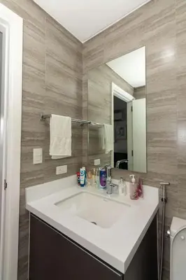 a bathroom with a white sink and a mirror at Century Spire Condominium, Makati City in Manila