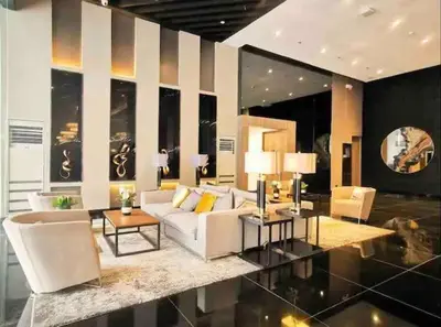 a living room with a white couch and chairs at air residences in Manila