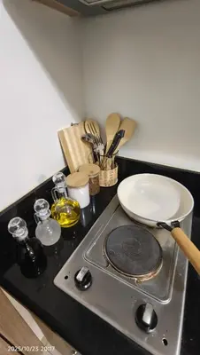 a stove top with a plate on top of it at Shore Residences Pasay in Manila
