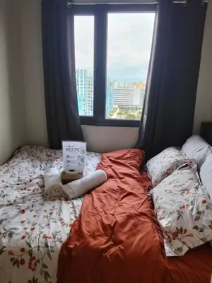 a bed in a room with a window at Pasay FL Staycation in Manila