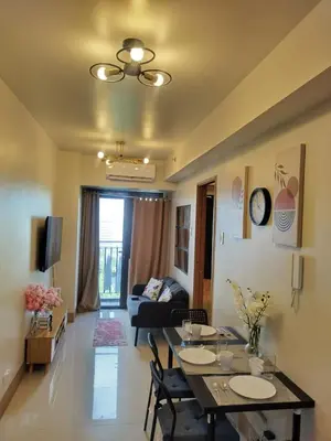 a living room with a table and a couch at Pasay FL Staycation in Manila