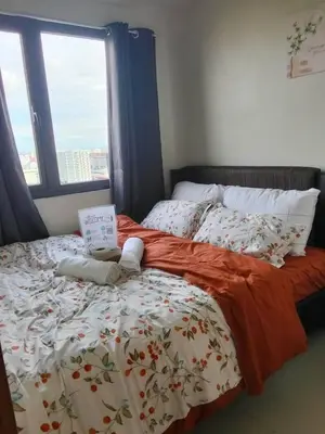 a bedroom with a bed with a laptop on it at Pasay FL Staycation in Manila