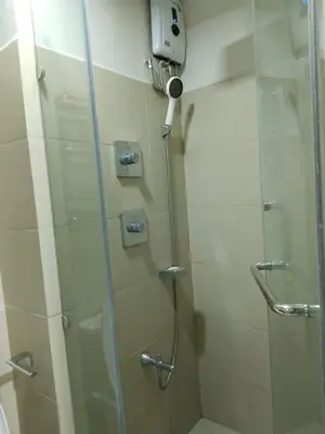 a shower with a glass door and a shower at Pasay FL Staycation in Manila