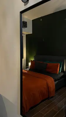 a mirror reflection of a bed in a room at Air Residences Minimal Style Unit w Balcony - Near Trident Tower and Salcedo in Manila