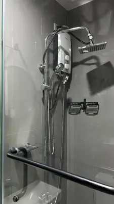 a shower stall with a hair dryer on a wall at Air Residences Minimal Style Unit w Balcony - Near Trident Tower and Salcedo in Manila