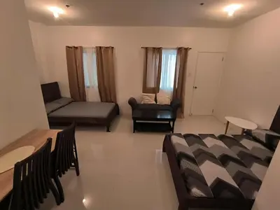 a living room with a couch and a chair at Yujia Apartment in Manila
