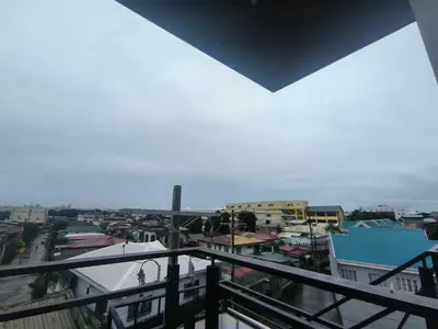 a view of a city from a balcony at Yujia Apartment in Manila