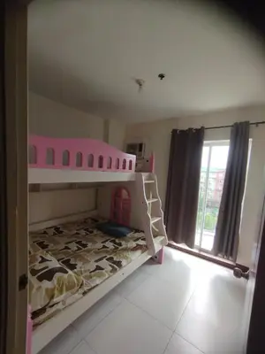 a childs bunk bed with a pink bunk bed at Chateau Elysee Condominium in Manila