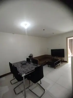 a living room with a table and a couch at Chateau Elysee Condominium in Manila