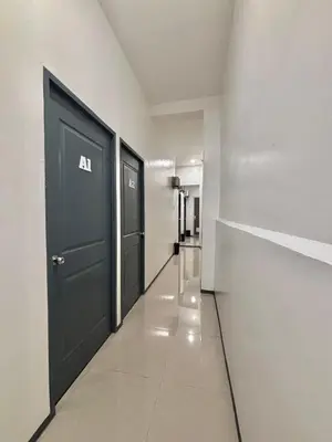 an empty hallway with two doors in a building at Pasay Transient Rooms in Manila
