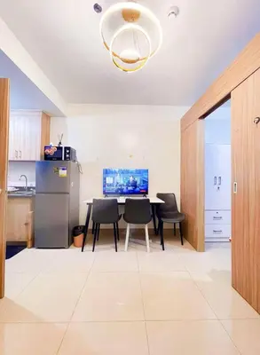 a kitchen with a table and chairs and a refrigerator at SHORE 2 TOWER 3 Near MOA Easy Vacation Shopping Center in Manila