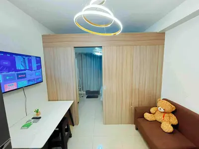 a teddy bear sitting on a couch in a room at SHORE 2 TOWER 3 Near MOA Easy Vacation Shopping Center in Manila