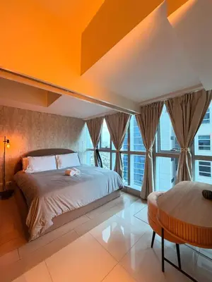 a bedroom with two beds and a large window at Cozy Modern- King Bed- City View in Manila