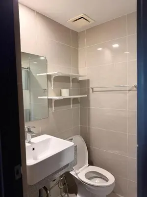 a bathroom with a sink and a toilet at Cozy Modern- King Bed- City View in Manila