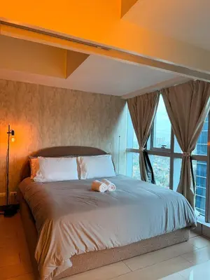 a bedroom with a large bed with an orange ceiling at Cozy Modern- King Bed- City View in Manila