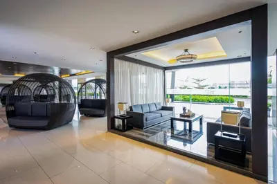 a living room with couches and a large window at Book ME at Shore Residences Tower D near Airport & Mall of Asia in Manila