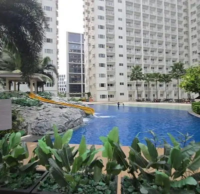 a swimming pool in the middle of a building at Book ME at Shore Residences Tower D near Airport & Mall of Asia in Manila