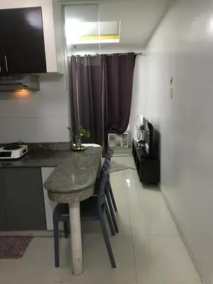 a kitchen with a table and chairs in a room at Birch Tower Manila by JL in Manila