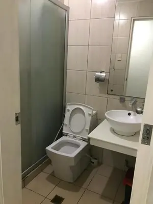 a bathroom with a toilet and a sink at Birch Tower Manila by JL in Manila