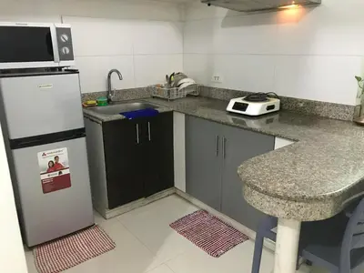 a kitchen with a refrigerator and a counter top at Birch Tower Manila by JL in Manila