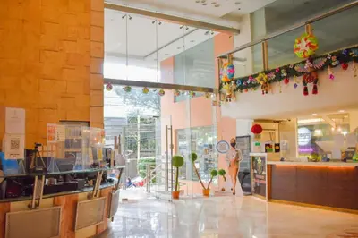 a lobby of a store with a person standing in it at Birch Tower Manila by JL in Manila