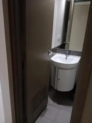 a bathroom with a toilet and a sink at Affordable condotel paranaque in Manila
