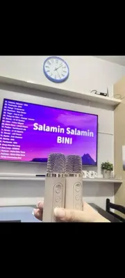 a person holding a remote control in front of a tv at Transient Home Serenity in Manila