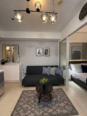 a living room with a couch and a table at Transient Home Serenity in Manila