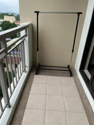 a balcony with a railing and a tile floor at Calathea Place - Bel's Cozy Staycation in Manila