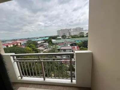 a balcony with a view of a city at Calathea Place - Bel's Cozy Staycation in Manila