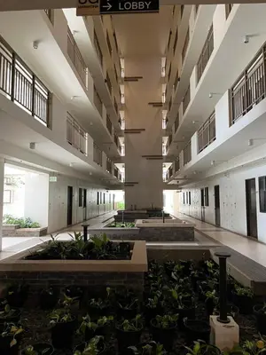 a large building with plants in the middle at Calathea Place - Bel's Cozy Staycation in Manila