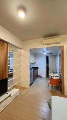 a living room with a kitchen and a dining room at 10P North Wing in Manila